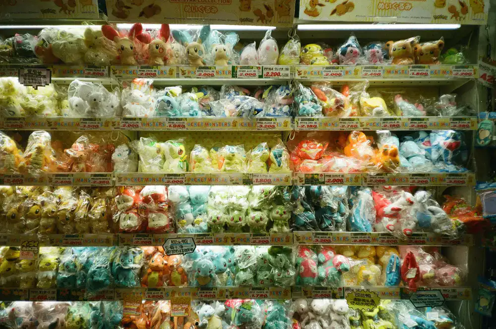 A variety of premium pet foods and colorful toys arranged neatly on wooden shelves.